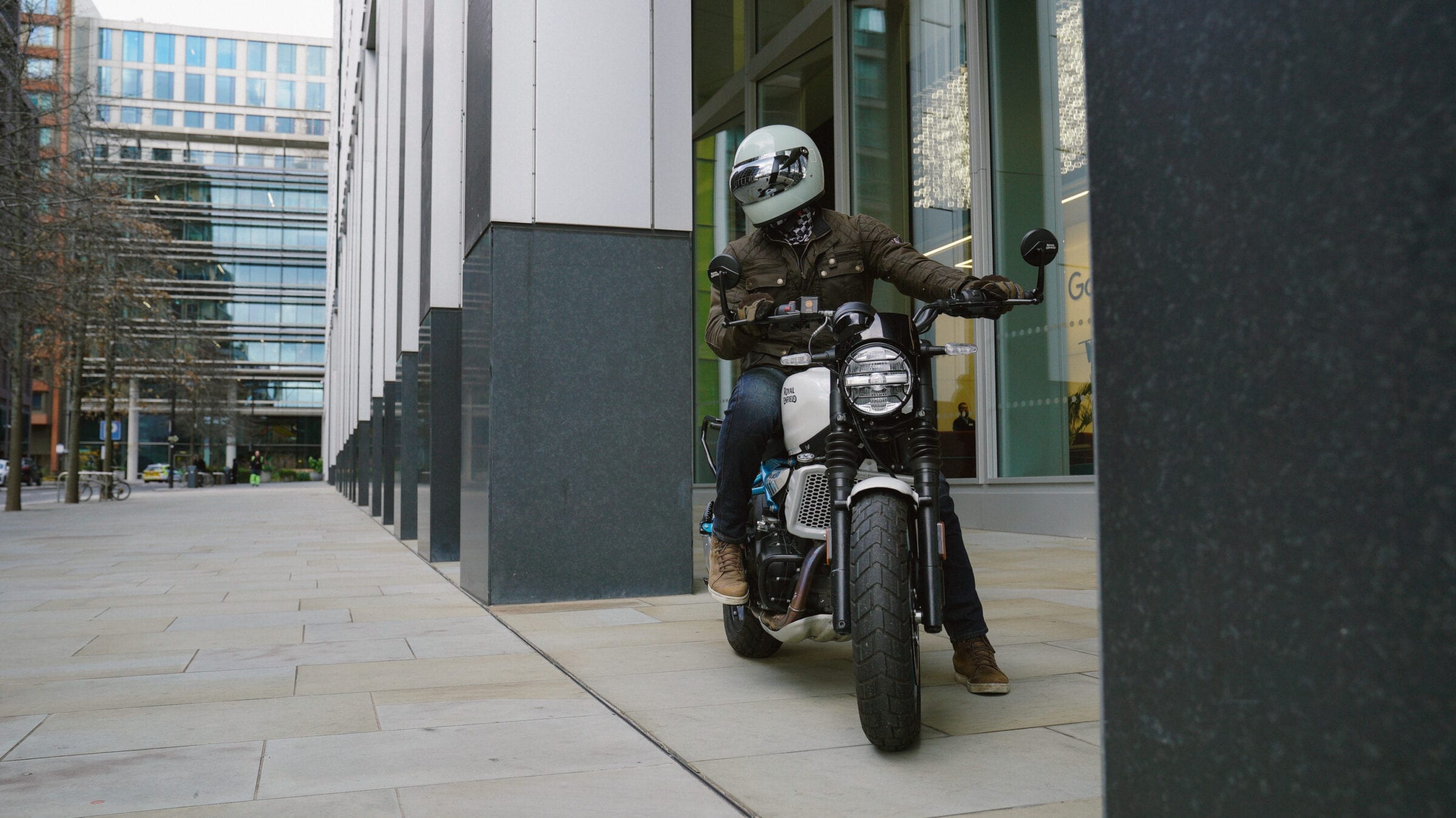 Rider posing on Royal Enfield Guerrilla 450, looking left